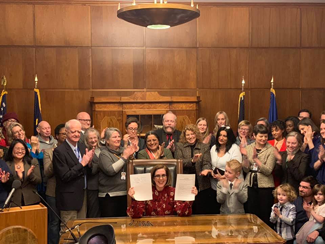 Governor Kate Brown signs Oregon’s historic rent regulation law on February 28, 2019